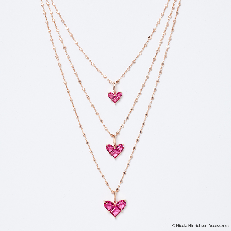 Three rose gold necklaces with pink heart pendant before straightening